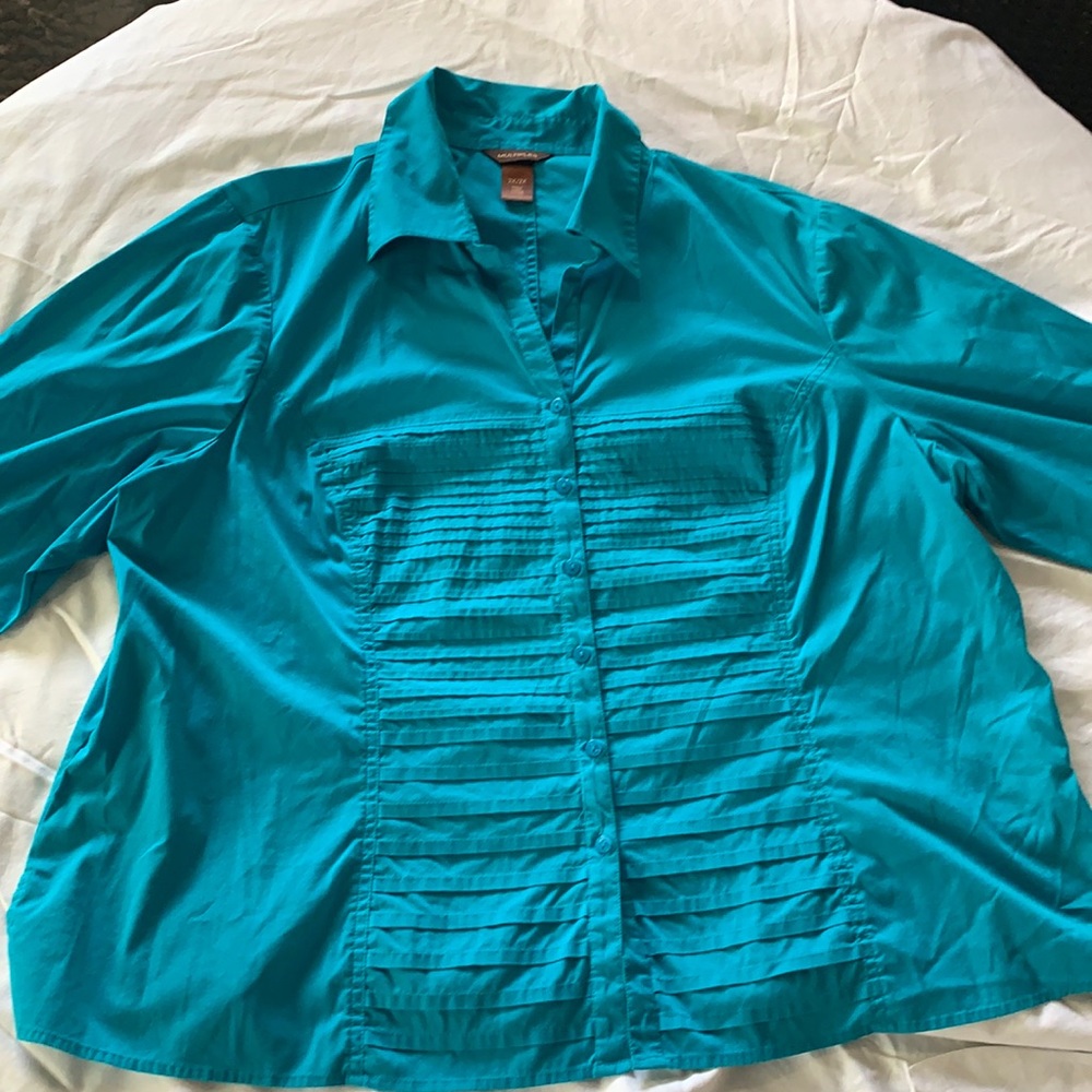 Women’s turquoise blouse, button down front,can be cuffed sleeves .